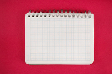 notepad open on a blank page against red background