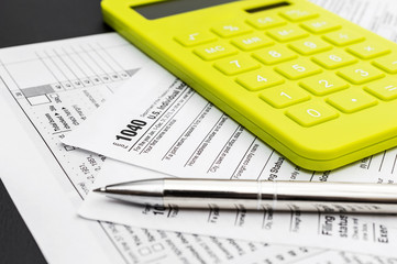 Tax forms with calculator and pen. Business and tax concept.