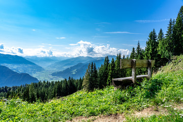 bench for resting while hiking and enjoying the green tyrol alm alps nature landscape in Austria