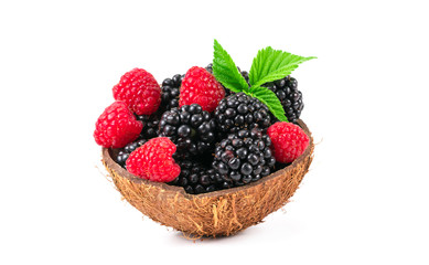 raspberries and blackberries in a basket isolated on white