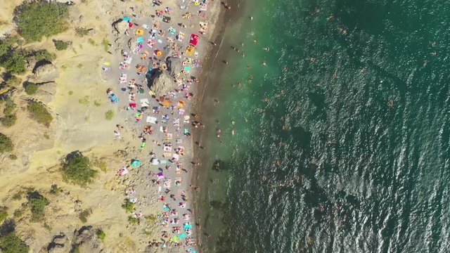 Flying Above Wild Sea  Beach With People. High Angle Aerial View. Black Sea, Novyi Svit, Crimea