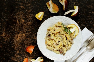 Fusilli paste with mushrooms Amanita Caesarea and boletus mushrooms and with cream. a family of fly-agarics of the highest category, a delicious mushroom. Italian Cuisine. copy space. top view  