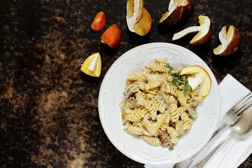Fusilli paste with mushrooms Amanita Caesarea and boletus mushrooms and with cream. a family of fly-agarics of the highest category, a delicious mushroom. Italian Cuisine. copy space. top view  