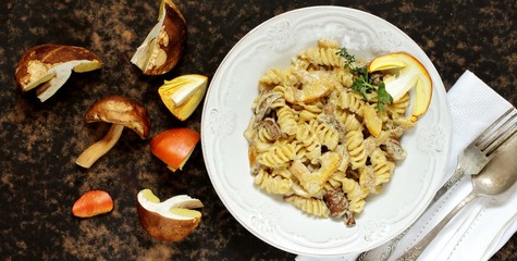 Fusilli paste with mushrooms Amanita Caesarea and boletus mushrooms and with cream. a family of fly-agarics of the highest category, a delicious mushroom. Italian Cuisine. copy space. top view  