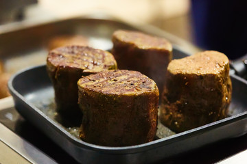 The beef steak in a frying pan. Shallow dof