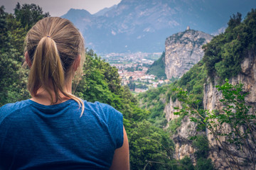 Climbing area, Massone, Arco, Italy. Climber - woman is looking to the valley. - obrazy, fototapety, plakaty