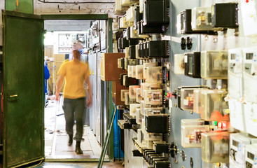 People work in a relay room at a power plant
