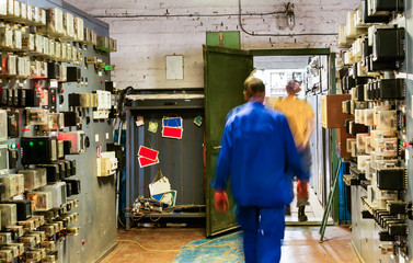 People work in a relay room at a power plant