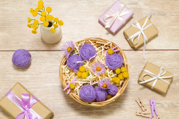 Small balls of thread in a basket. Gift boxes. Clothespins