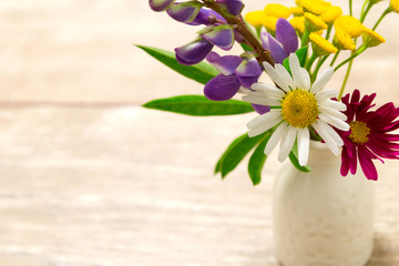A small vase with flowers. Mother's Day Holidays Concept. Valentine's Day.