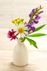 A small vase with flowers. Mother's Day Holidays Concept. Valentine's Day.
