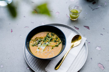 Pumpkin cream soup on light gray background