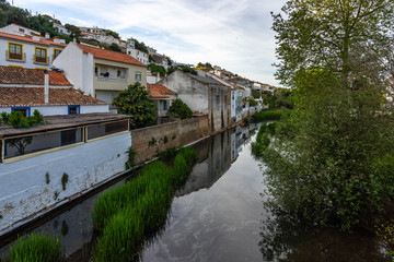Fototapeta na wymiar Houses reflecting in a river in the small town of Aljezur, Algarve, Portugal,