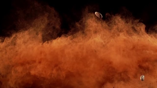 Chocolate Cacao and Cacao beans collide on black background closeup in super slow motion