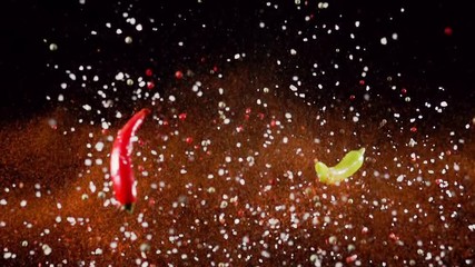 Exotic Spices paprika chili variation salt and peppercorn collide on black background closeup in super slow motion