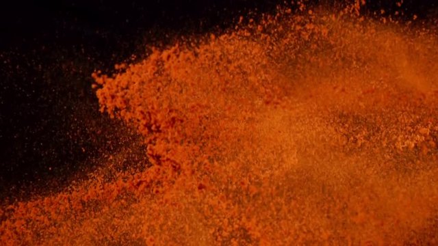 Exotic Spices paprika  collide on black background closeup in super slow motion