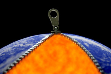 Climate change, illustrated by Earth-like fabric ball with opened zipper revealing fire. Globe image from NASA.