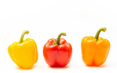Variety of thre different colored bell peppers isolated on white