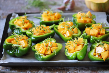 Paprika peppers stuffed with pumpkin. Baked paprika with pumpkin. Vegan lunch. Autumn food. Selective focus. Macro.