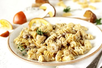 Fusilli paste with mushrooms Amanita Caesarea and boletus mushrooms and with cream. a family of fly-agarics of the highest category, a delicious mushroom. Italian Cuisine.