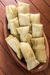 Pamonha. Brazilian Corn Snack on wooden basket in Brazil