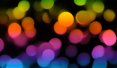 Multicolored defocused bokeh lights abstract on a dark background