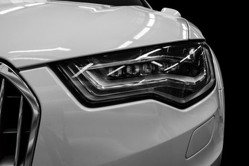 Modern car headlight background. Lights reflections on the modern car.