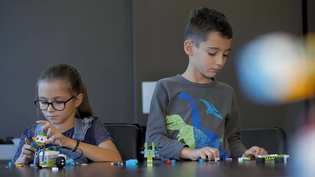 Children in the classroom make figure from the designer