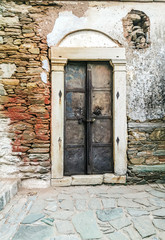 old rustic metal door of old stone building