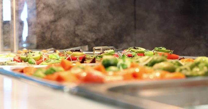 Close-up of gourmet zucchini and tomato meal with steam in the background.