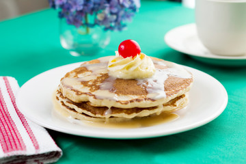 Delicious tres leches pancakes with cherry on top