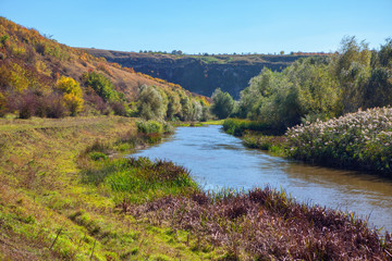 Fototapeta na wymiar autumnal scenery with river and green hills