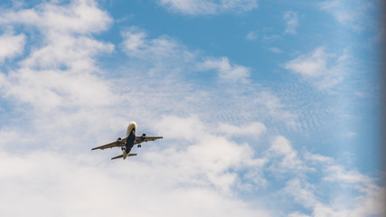 Jetliner at low altitude with clouds in the background