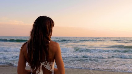 Beautiful woman in a white dress at the beach at sunset - Powered by Adobe