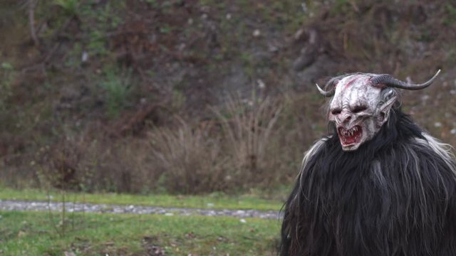 krampus austrian tradition white face standing in meadow