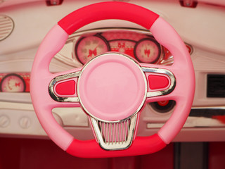 Dashboard baby pink car. View of the steering wheel.