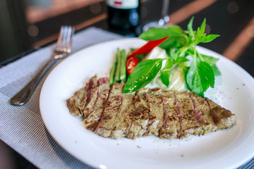steak in a white dish