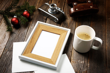 Photos, camera, pine tree branch and cup of coffee