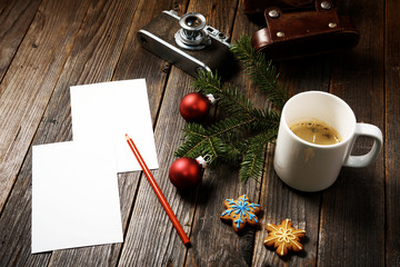 Photos, camera, pine tree branch and cup of coffee