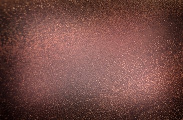 Fototapeta na wymiar Golden dust on brown background. Luxury holiday style. Shimmer coffee color abstraction. Glitter texture.