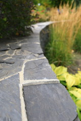 Stone curved retaining wall in garden