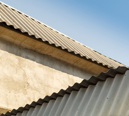 Concrete walls and asbestos slate on the roof.