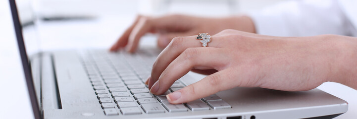 Businesswoman in the office holds her hand on the laptop makes financial analysis and calculation...