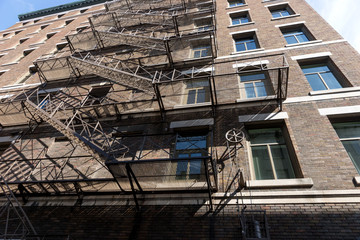 Fire escape stairs and ladder on a typical old brick building from Quebec, Canada