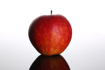 fresh red apple on a background with reflection