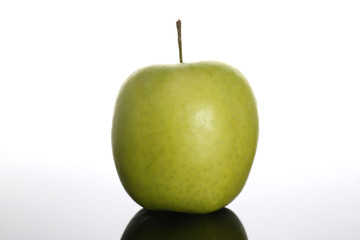 fresh green apple on a background with reflection