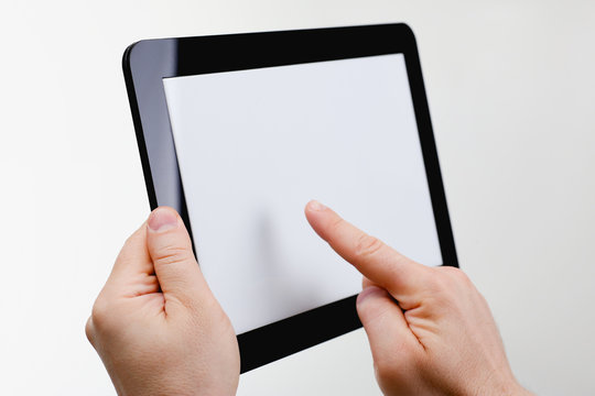 Man hoding black tablet frame in hand isolated on white closeup. Can insert an image image your text for the concept or project development of mobile applications, their advertising for mobile devices