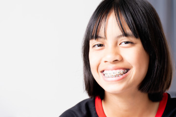 Girl with dental braces smiling and happy