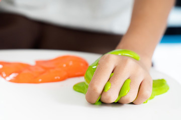 Hand Holding Homemade Toy Called Slime or Goop, Kids having fun and being creative by science experiment