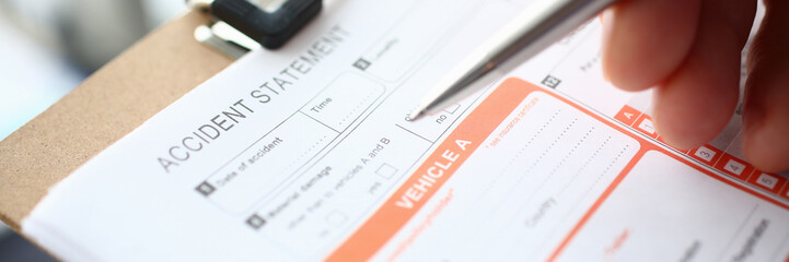 Male insurer hand hold silver pen an accident europrotocol closeup. Risk transportation representative insurance company investigating interrogation victims help prepare sending method letter concept